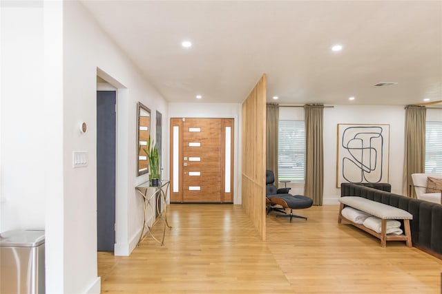 729 Bizerte Ave, Dallas, TX 75224 - entryway with light wood-type flooring, recessed lighting, plenty of natural light, and baseboards