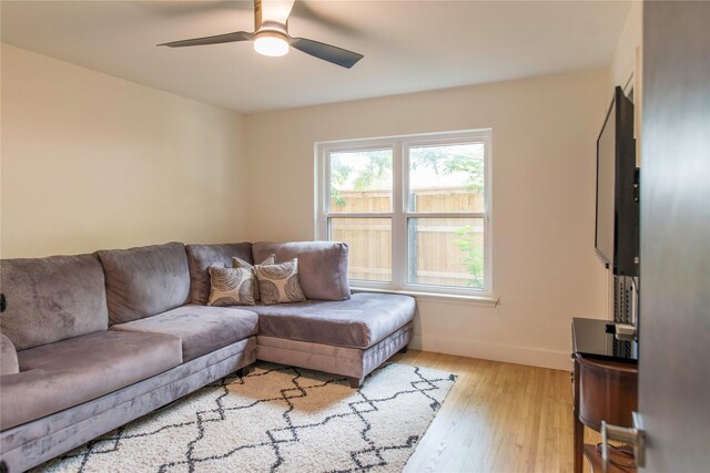 729 Bizerte Ave, Dallas, TX 75224 - living room with ceiling fan, baseboards, and light wood finished floors