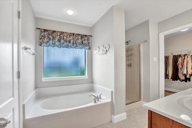 2400 Silver Maple Dr, Saint Paul, TX 75098 - bathroom featuring a bath, a shower stall, vanity, tile patterned floors, and a spacious closet