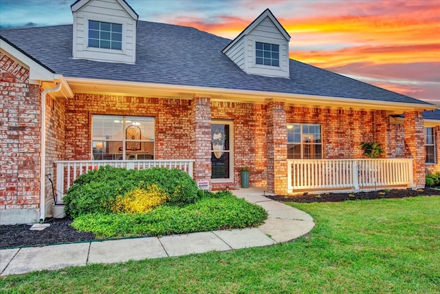 2400 Silver Maple Dr, Saint Paul, TX 75098 - view of front of home featuring a porch, brick siding, a front lawn, and roof with shingles