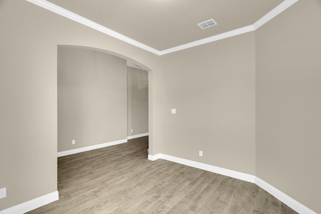 449 Hillstone Dr, Midlothian, TX 76065 - unfurnished room with ornamental molding, arched walkways, wood finished floors, and baseboards