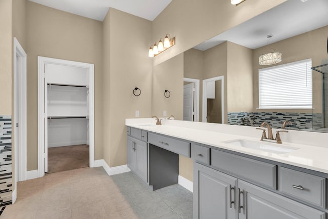 449 Hillstone Dr, Midlothian, TX 76065 - bathroom with double vanity, a spacious closet, tile patterned flooring, and baseboards