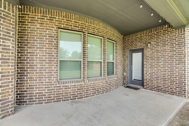 449 Hillstone Dr, Midlothian, TX 76065 - doorway to property featuring brick siding and a patio area
