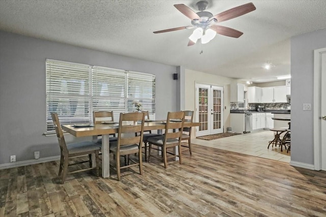 4325 Falcon Dr, Sherman, TX 75092 - dining space with french doors, light wood-type flooring, ceiling fan, a textured ceiling, and baseboards