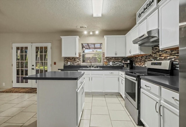 4325 Falcon Dr, Sherman, TX 75092 - kitchen featuring stainless steel electric range oven, ventilation hood, a sink, dark countertops, and backsplash