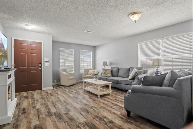 4325 Falcon Dr, Sherman, TX 75092 - living area featuring wood finished floors, a textured ceiling, and baseboards