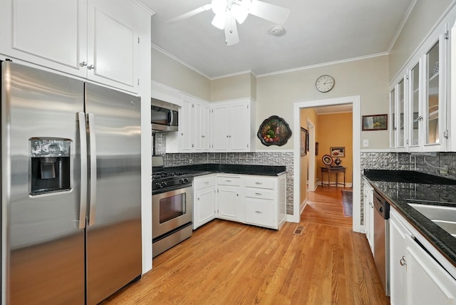 1125 Sayles Blvd, Abilene, TX 79605 - kitchen featuring stainless steel appliances, backsplash, ceiling fan, white cabinets, and ornamental molding