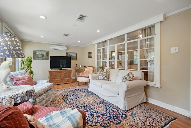 1125 Sayles Blvd, Abilene, TX 79605 - living area featuring a wall unit AC, wood finished floors, ornamental molding, recessed lighting, and baseboards