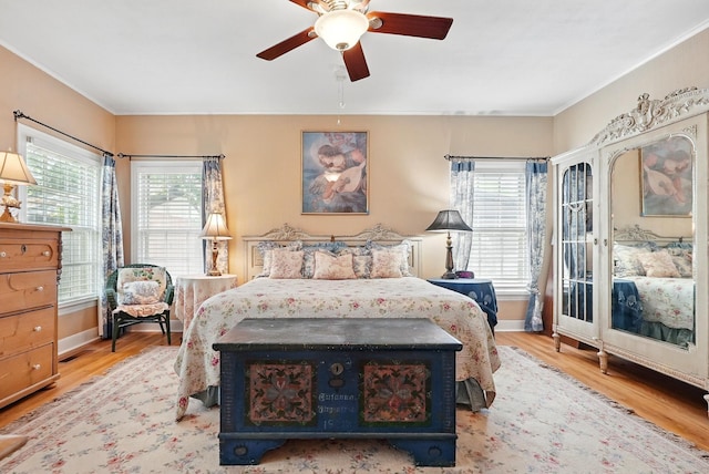 1125 Sayles Blvd, Abilene, TX 79605 - bedroom featuring wood finished floors, crown molding, baseboards, and a ceiling fan