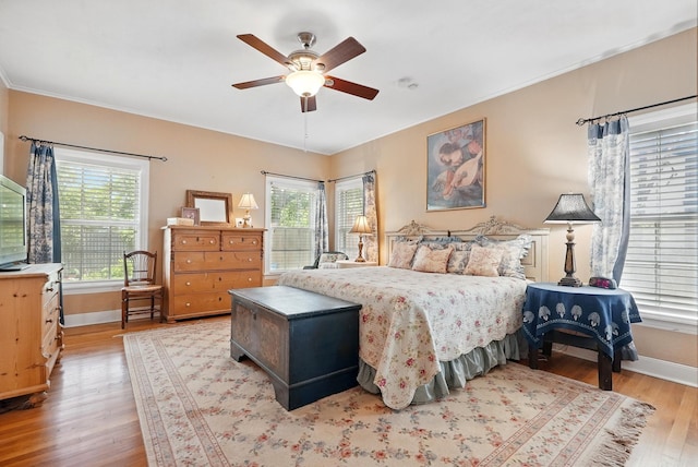 1125 Sayles Blvd, Abilene, TX 79605 - bedroom featuring wood finished floors, baseboards, and a ceiling fan