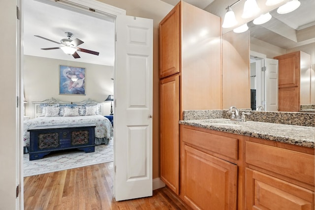 1125 Sayles Blvd, Abilene, TX 79605 - bathroom featuring connected bathroom, wood finished floors, vanity, and ceiling fan