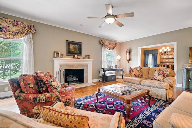 1125 Sayles Blvd, Abilene, TX 79605 - living room with wood finished floors, ceiling fan, a chandelier, a premium fireplace, and baseboards