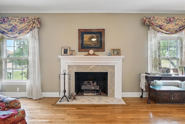 1125 Sayles Blvd, Abilene, TX 79605 - living room with wood finished floors, healthy amount of natural light, ornamental molding, a premium fireplace, and baseboards