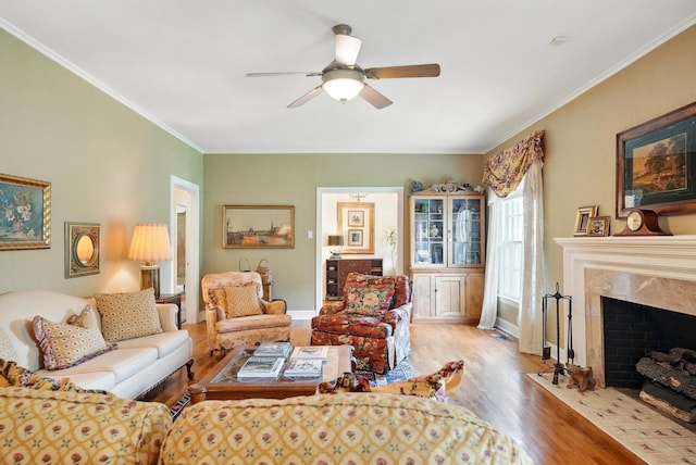 1125 Sayles Blvd, Abilene, TX 79605 - living area with wood finished floors, a ceiling fan, a fireplace, crown molding, and baseboards