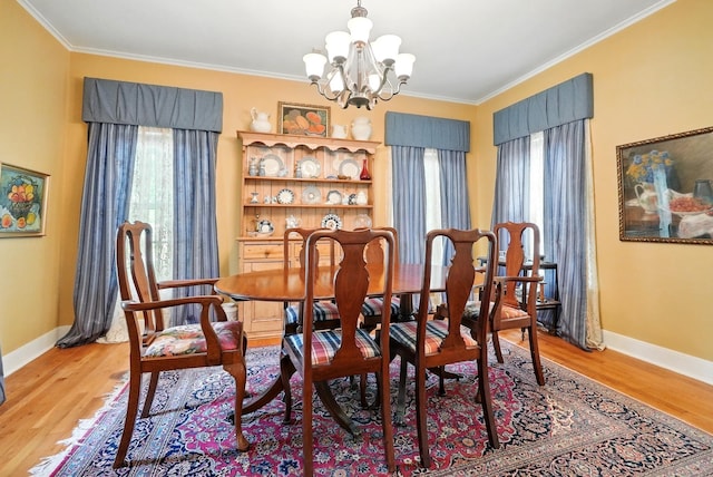 1125 Sayles Blvd, Abilene, TX 79605 - dining space with a chandelier, ornamental molding, light wood-style floors, and baseboards
