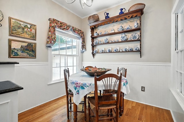 1125 Sayles Blvd, Abilene, TX 79605 - dining area with ornamental molding, light wood-type flooring, wainscoting, and a chandelier