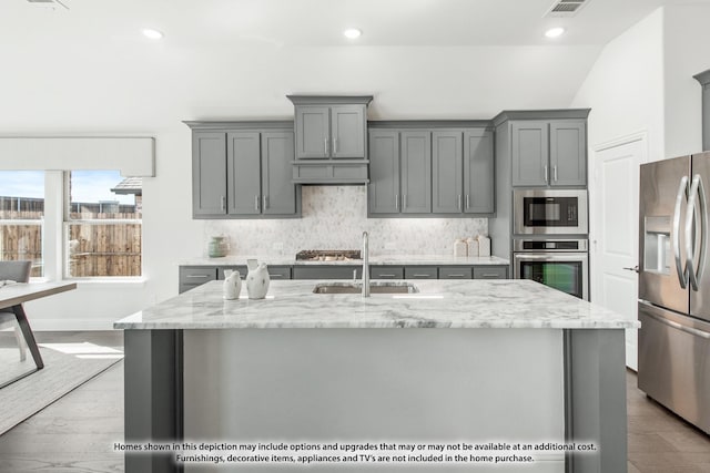 4031 Zina Ln, Prosper, TX 75078 - kitchen with appliances with stainless steel finishes, gray cabinetry, a sink, recessed lighting, and lofted ceiling