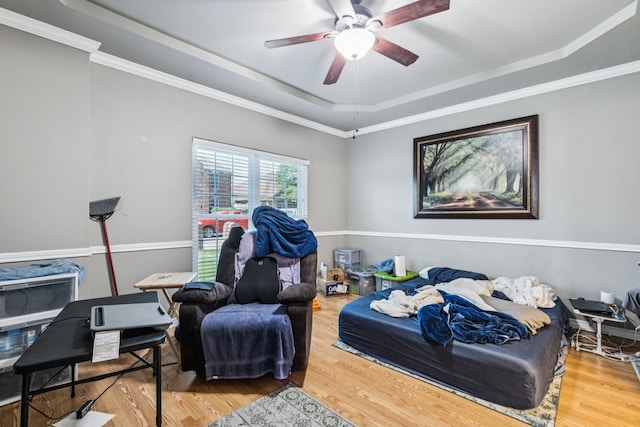 412 Kyle Ln, Lewisville, TX 75067 - bedroom featuring a raised ceiling, wood finished floors, crown molding, and a ceiling fan