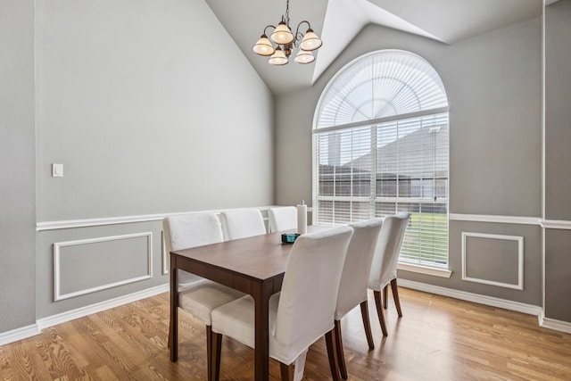 412 Kyle Ln, Lewisville, TX 75067 - dining area with a chandelier, light wood-style flooring, lofted ceiling, and baseboards