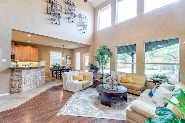 12744 Concho Dr, Frisco, TX 75033 - living area with a towering ceiling, wood finished floors, and baseboards