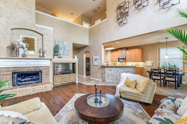 12744 Concho Dr, Frisco, TX 75033 - living area with a stone fireplace, dark wood finished floors, and a high ceiling