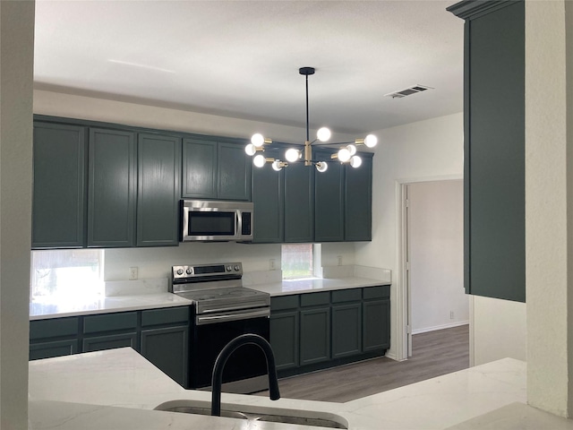 3822 Balsam Fir Dr, Garland, TX 75043 - kitchen with stainless steel appliances, a sink, light stone countertops, and light wood-type flooring