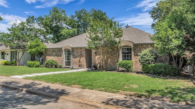 8534 Vista View Dr, Dallas, TX 75243 - view of front of house with brick siding, a front yard, and a shingled roof