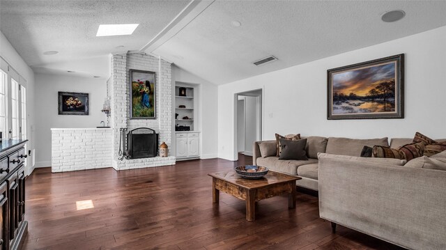 8534 Vista View Dr, Dallas, TX 75243 - living area with a textured ceiling, vaulted ceiling, built in features, wood finished floors, and a fireplace