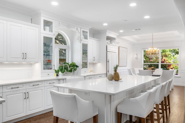 4009 Tave Ct, Arlington, TX 76016 - kitchen featuring white cabinetry, a kitchen breakfast bar, plenty of natural light, recessed lighting, and ornamental molding