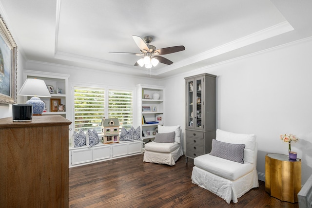 4009 Tave Ct, Arlington, TX 76016 - sitting room featuring a raised ceiling, dark wood-type flooring, ceiling fan, crown molding, and built in features