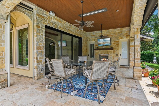 6203 Sweeney Trl, Frisco, TX 75034 - view of patio / terrace featuring a ceiling fan, outdoor dining area, and an outdoor stone fireplace