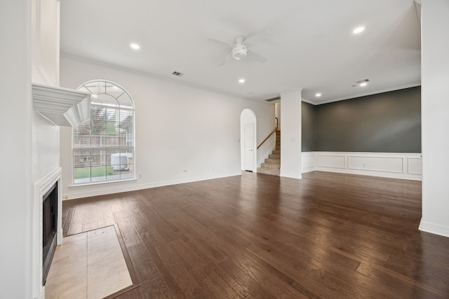 5836 Oram St, Dallas, TX 75206 - unfurnished living room with a fireplace, ceiling fan, stairs, crown molding, and hardwood / wood-style floors