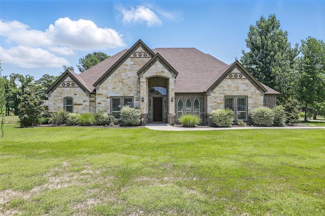 209 Ellis Creek Dr, Weatherford, TX 76085 - french country inspired facade with stone siding, a front yard, and a shingled roof
