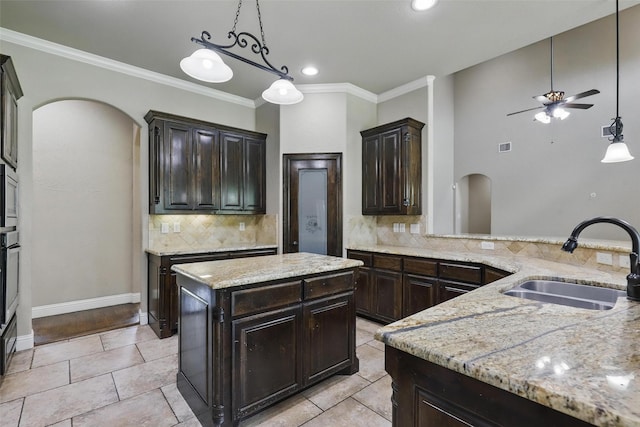 209 Ellis Creek Dr, Weatherford, TX 76085 - kitchen with a sink, arched walkways, tasteful backsplash, a ceiling fan, and pendant lighting