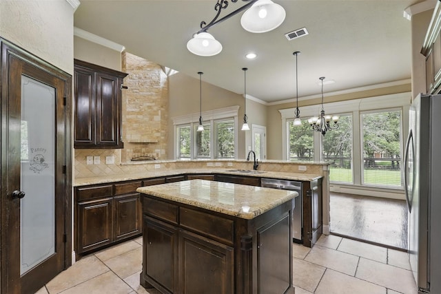 209 Ellis Creek Dr, Weatherford, TX 76085 - kitchen with appliances with stainless steel finishes, a sink, a peninsula, light tile patterned floors, and tasteful backsplash