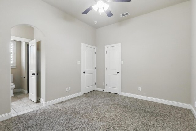 209 Ellis Creek Dr, Weatherford, TX 76085 - unfurnished bedroom with carpet flooring, arched walkways, ensuite bath, baseboards, and lofted ceiling