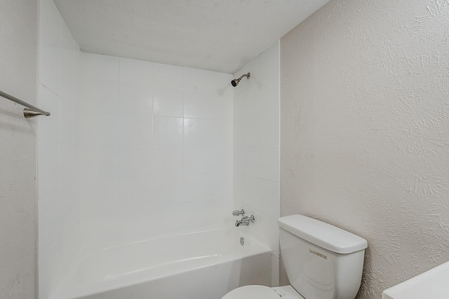 7108 Christie Ln, Dallas, TX 75249 - bathroom featuring toilet, shower / bath combination, and a textured wall