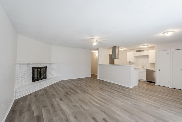 7108 Christie Ln, Dallas, TX 75249 - unfurnished living room featuring a sink, ceiling fan, light wood finished floors, and baseboards