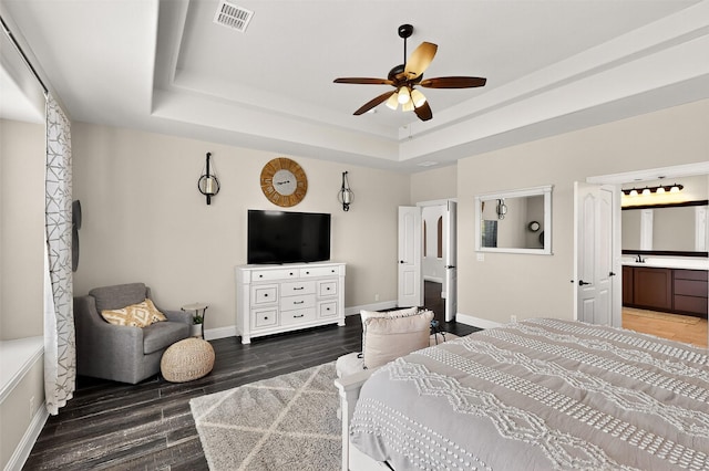 734 Oakleaf Dr, Midlothian, TX 76065 - bedroom featuring baseboards, a raised ceiling, wood finished floors, and ensuite bath