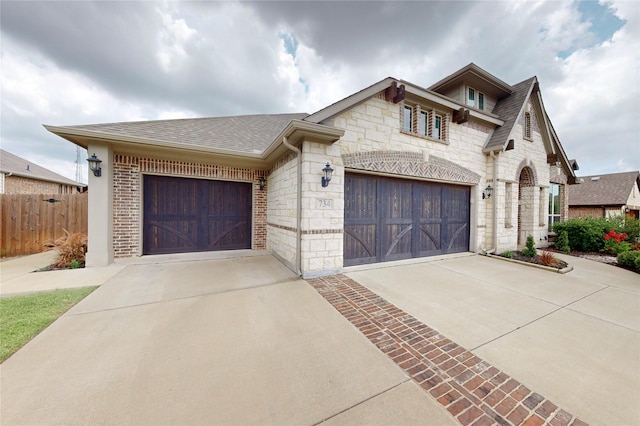 734 Oakleaf Dr, Midlothian, TX 76065 - french country inspired facade with concrete driveway, stone siding, brick siding, and roof with shingles
