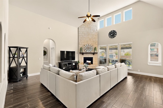 734 Oakleaf Dr, Midlothian, TX 76065 - living area with high vaulted ceiling, ceiling fan, arched walkways, dark wood finished floors, and baseboards