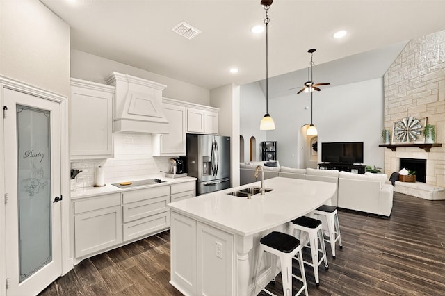 734 Oakleaf Dr, Midlothian, TX 76065 - kitchen with a sink, stainless steel fridge, tasteful backsplash, black electric cooktop, and custom range hood
