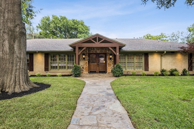 6942 Desco Pl, Dallas, TX 75225 - ranch-style home featuring a front lawn, roof with shingles, and stone siding