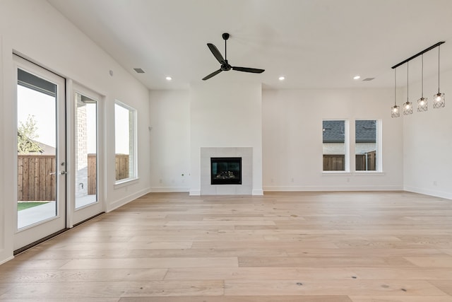 609 Cork Dr, Celina, TX 75009 - unfurnished living room with light wood finished floors, recessed lighting, ceiling fan, and a tiled fireplace