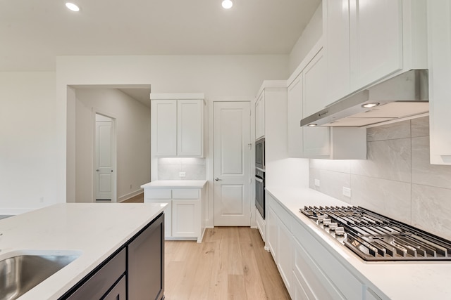 609 Cork Dr, Celina, TX 75009 - kitchen featuring stainless steel appliances, under cabinet range hood, white cabinets, decorative backsplash, and recessed lighting