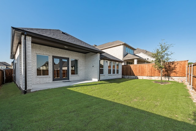 609 Cork Dr, Celina, TX 75009 - back of property featuring brick siding, a fenced backyard, a patio, roof with shingles, and french doors