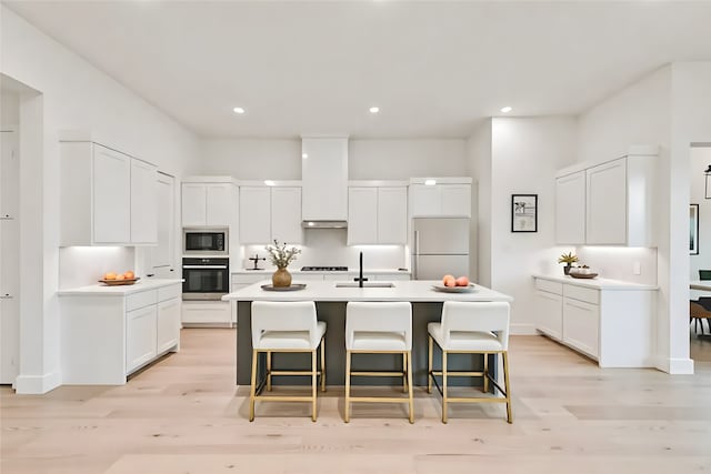 609 Cork Dr, Celina, TX 75009 - kitchen featuring oven, black microwave, white refrigerator, light wood-style floors, and recessed lighting