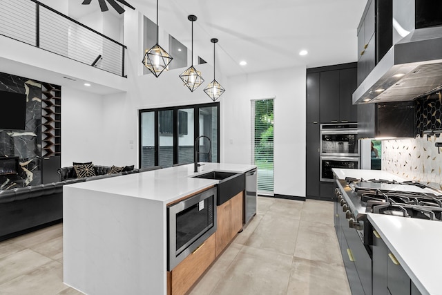 2303 Timber Creek Ct, Cedar Hill, TX 75104 - kitchen featuring appliances with stainless steel finishes, modern cabinets, a sink, dark cabinetry, and wall chimney range hood