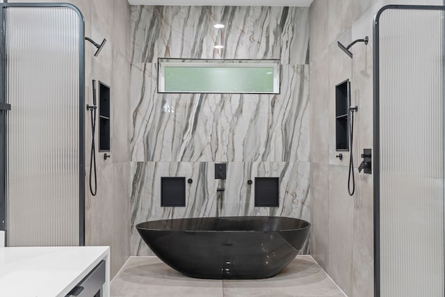 2303 Timber Creek Ct, Cedar Hill, TX 75104 - full bath featuring a walk in shower, tile walls, a freestanding bath, and vanity