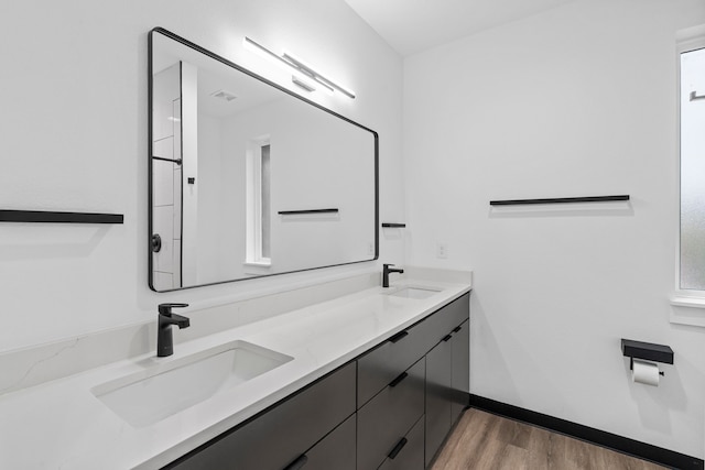 2303 Timber Creek Ct, Cedar Hill, TX 75104 - full bathroom with double vanity, wood finished floors, and baseboards